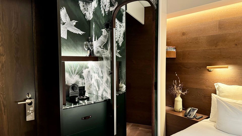 The minibar is hidden within the wardrobe.