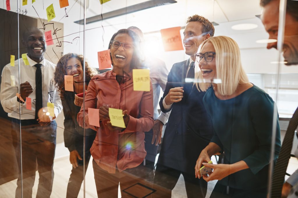 Laughing businesspeople having a brainstorming session in an off