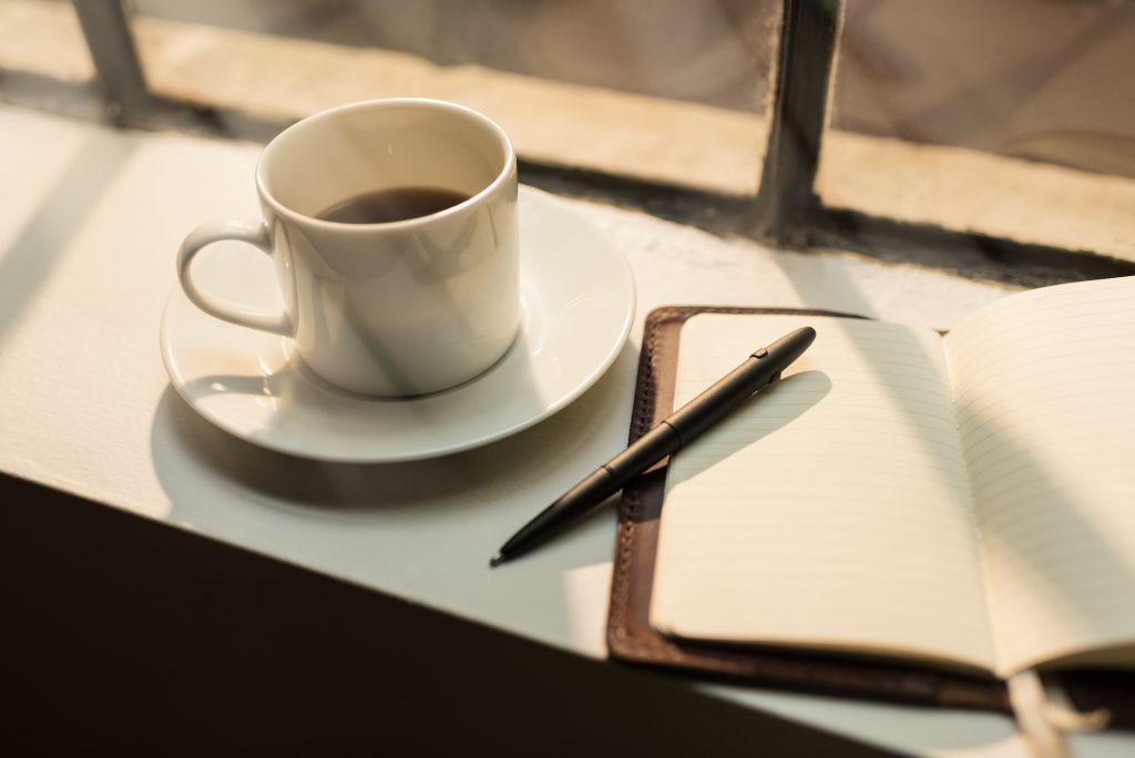 Blank leather journal and coffee