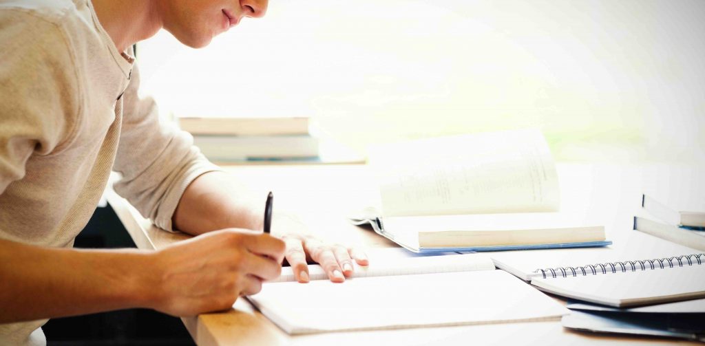 male student writing, academic writing